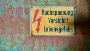 feature image rusty German high voltage sign